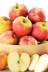 Composition with apples in basket isolated on white