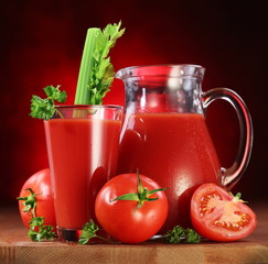Tomatoes, jug and glass full of fresh tomatoes juice