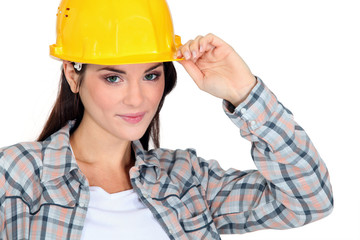 Female builder touching hat