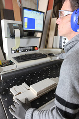 Man operating machinery wearing ear defenders