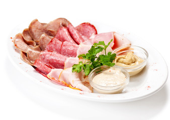 Meat delicatessen plate with souce