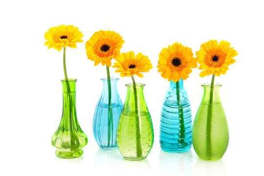 Yellow Gerber flowers in little glass vases