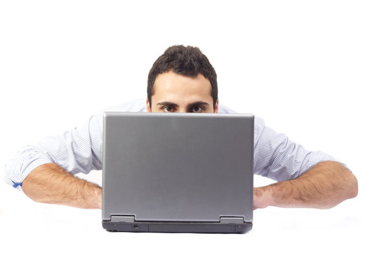Young man behind a laptop