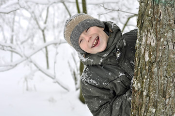 smiling boy in winter forest