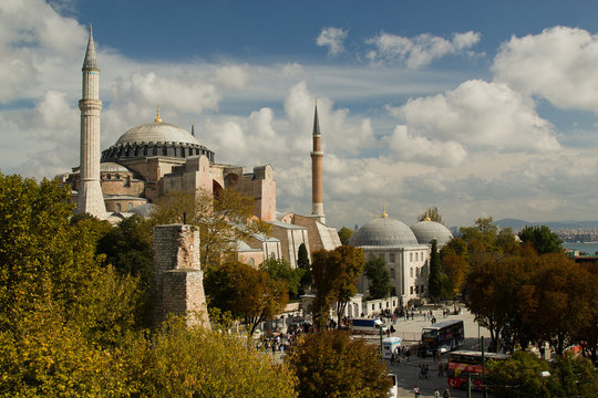 Hagia Sofia in Istanbul, side view with trees and clouds