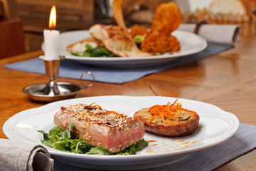 Fried tuna steak and potatoes on the plate