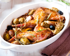 Oven baked rabbit legs with olives and rosemary