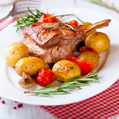 Roast rack of veal with baked vegetables and rosemary
