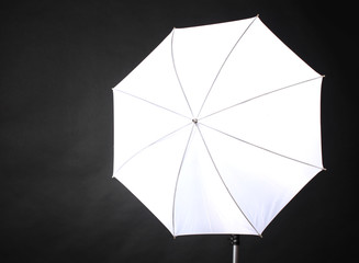 Studio flash with umbrella on grey background