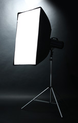 Studio flash with soft-box  on black studio background