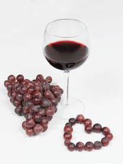glass of wine with grapes and heart