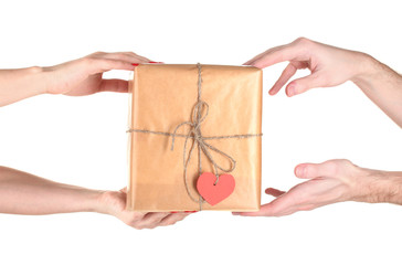Woman's hand giving parcel with blank heart-shaped label to man