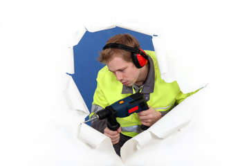 Man with drill and muffs