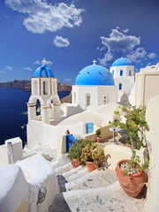 View of blue dome church in Oia village on Santorini island