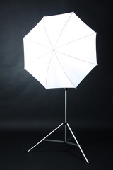 Studio flash with umbrella on grey background