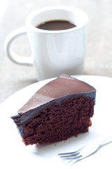 Chocolate cake with cup of coffee