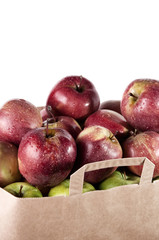 Fresh apples in a paper bag isolated over white