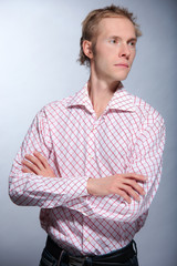 Pretty young man posing on light background