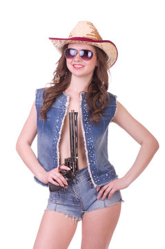 Pretty girl with cowboy hat with revolver