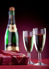 Romantic gift box, two glasses and a bottle of champagne.