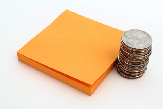 Coins and orange note pad