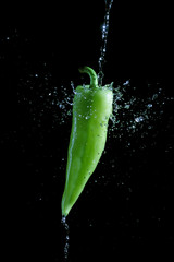 Green pepper splashed by water