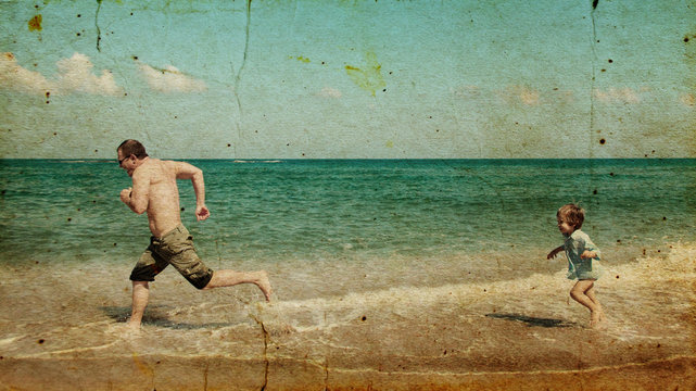 father and son on the beach. Photo in old image style.