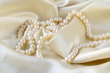 Pearls a necklace on a silk fabric