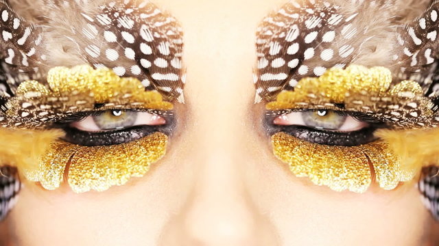 Gold leaf and feather eye makeup