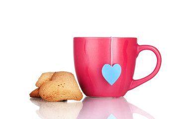 red cup with tea bag and heart-shaped cookies isolated on white