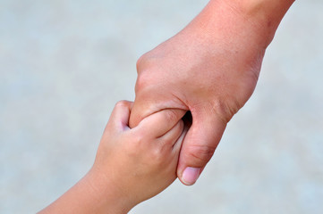 Adult and child's hands holding
