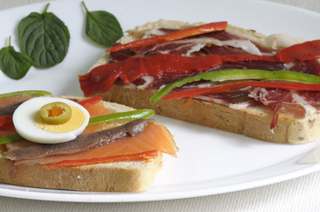 Canapes with smoked salmon, peppers, egg and ham