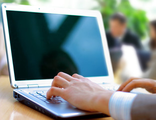 Person Typing on a modern laptop in an office