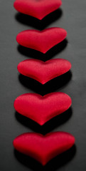 Obraz premium red hearts on black background