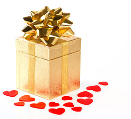 golden gift box with bow and red hearts decoration
