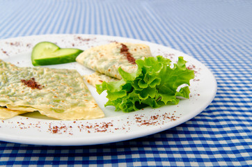 Pancake with herbs in the plate