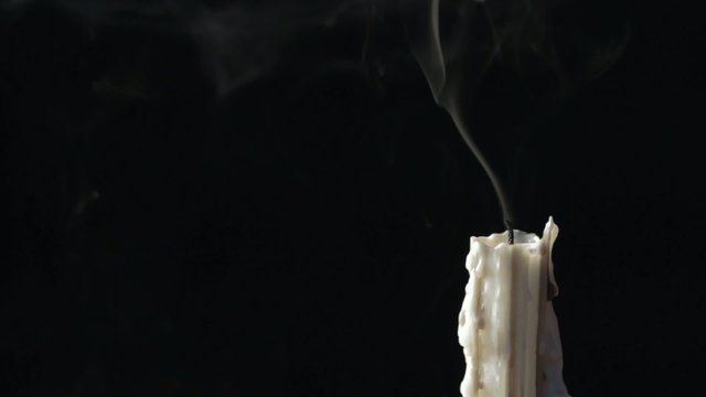 Candle blow off with smoke isolated on black background