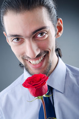 Young man with red rose