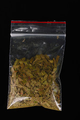marihuana in package on black background