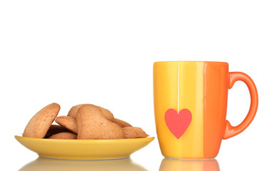 Orange cup with tea bag and heart-shaped cookies