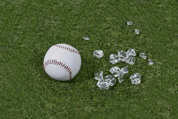 Baseball and Broken Glass on Grass