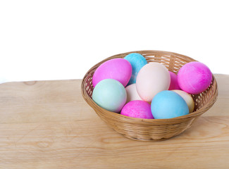 Wicker basket of colored eggs