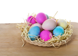 Fototapeta na wymiar Wicker tray of colored eggs