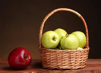 juicy green apples in basket and red apple