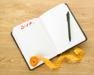 Planning of diet. Notebook measuring tapes and pen