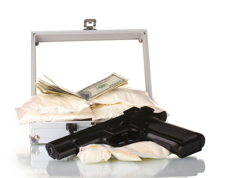 Cocaine with money and gun in a suitcase isolated on white