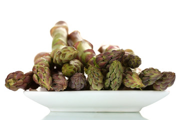 delicious fresh asparagus on a plate isolated on white