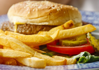 Golden French Fries with Cheeseburger in Background