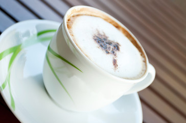 Cup of cappuccino coffee on wood table