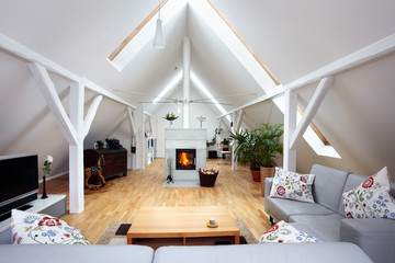 large, attractive attic room with wood-burning fireplace - obrazy, fototapety, plakaty